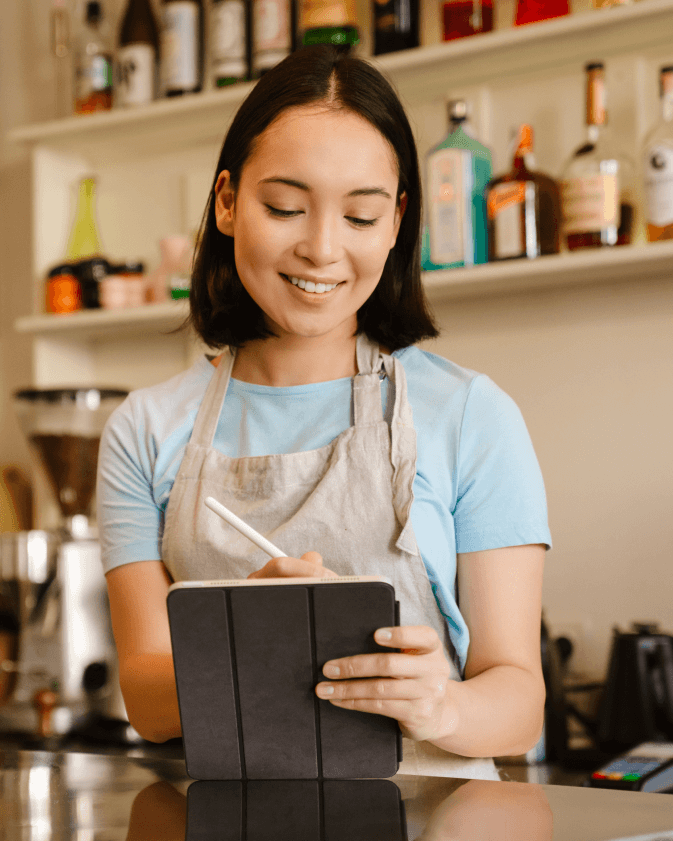 women taking orders through restaurant POS system.